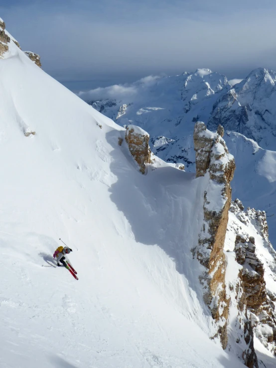 a person on skis skiing up a snow covered mountain