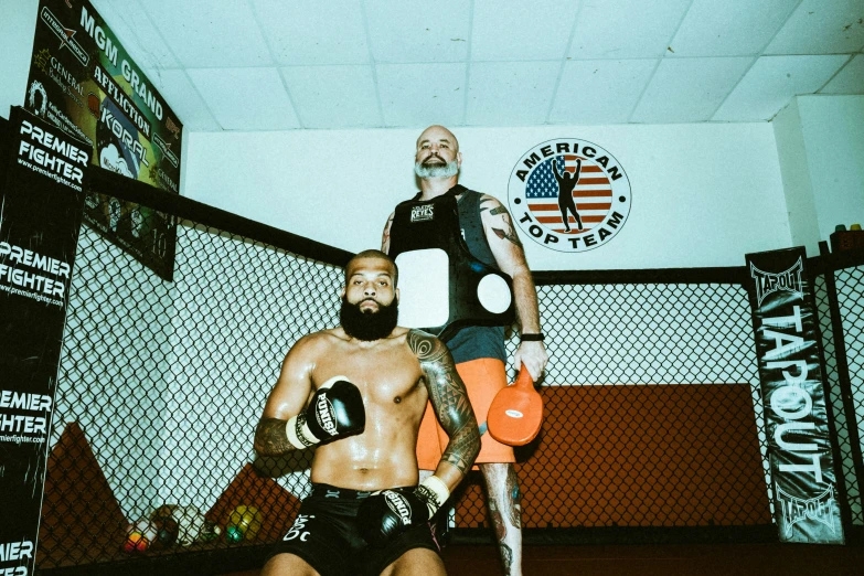 two men in boxing trunks in a boxing ring