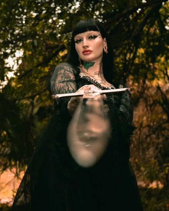 a woman wearing a black dress holds a white clock