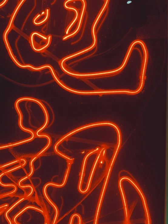 a large red neon light displays a black background