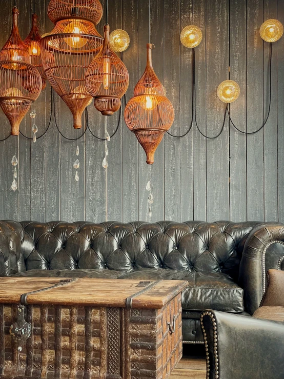 several chandeliers hang over a couch in a room