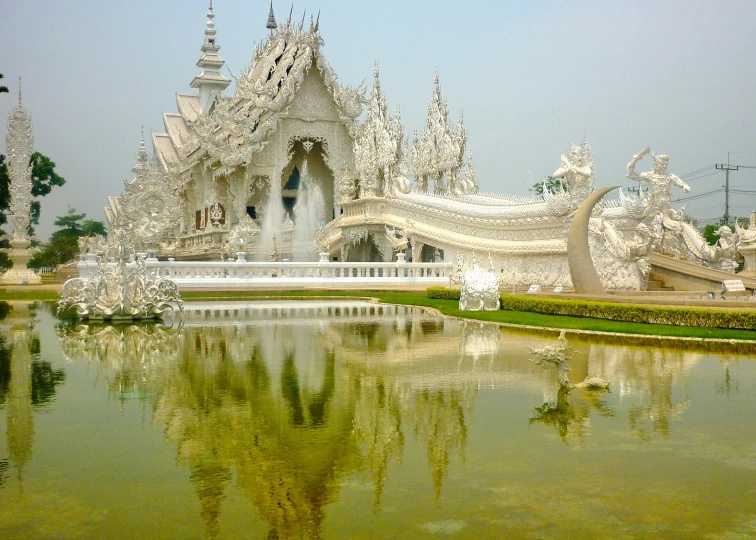 a very fancy white building sitting on top of a body of water