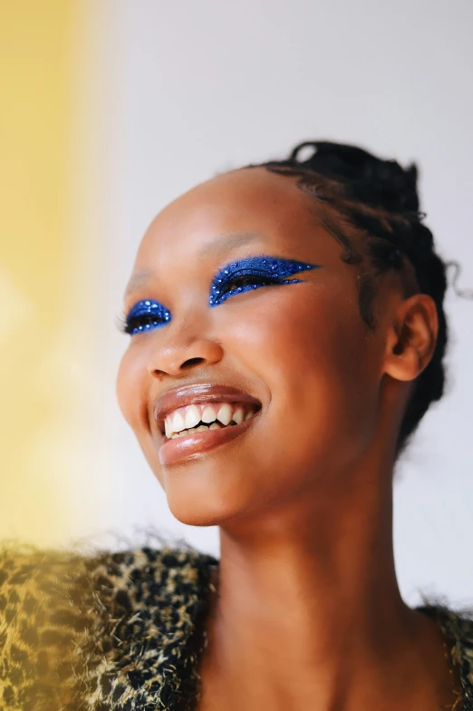 a girl with blue eyes and black hair smiling