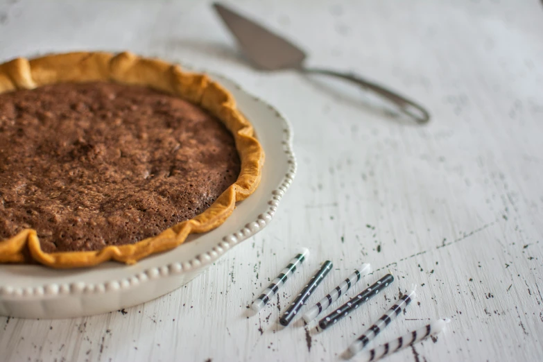 a pie sitting on top of a white wooden table