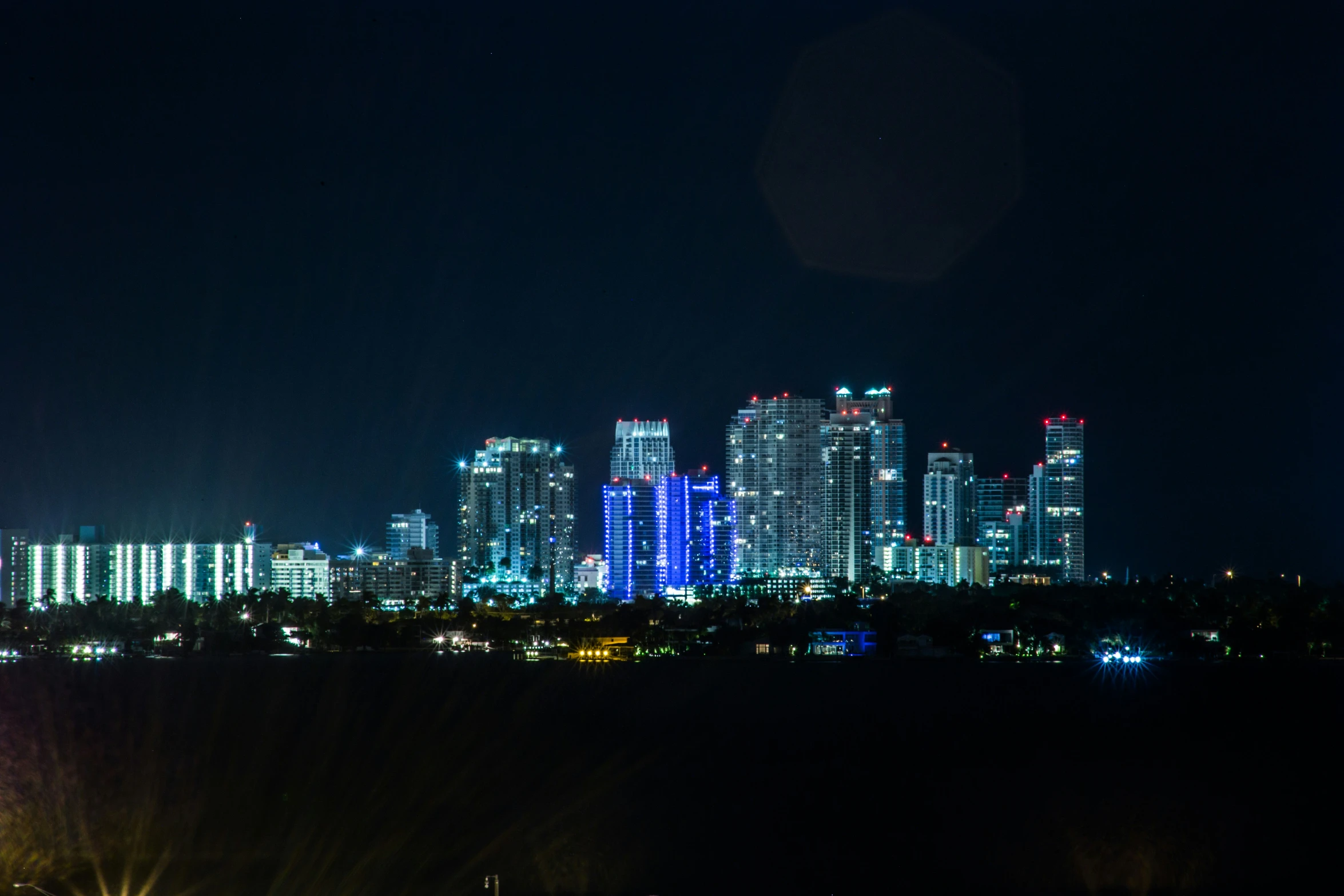 a city skyline with a lot of bright lights at night