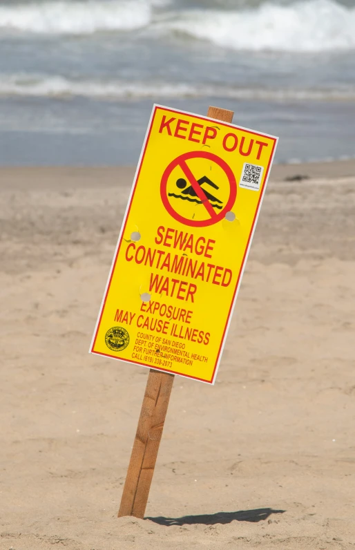 a sign is shown on the beach to avoid diving