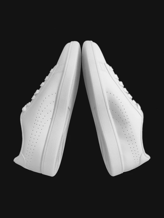 a pair of white sneakers side by side