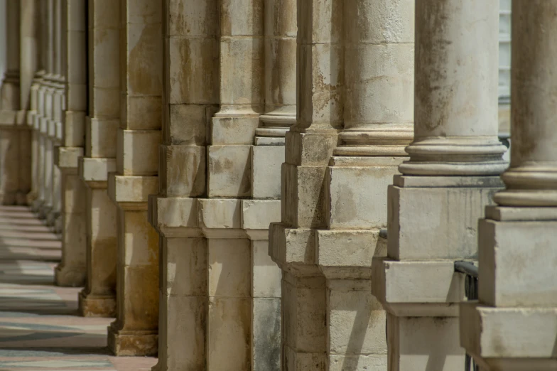a row of columns in a building that is lined with stone