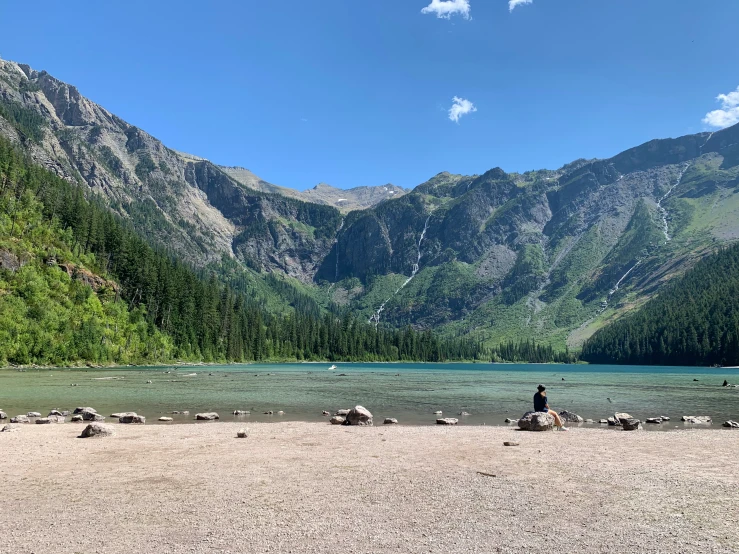 the mountains surrounding a shallow lake on a sunny day