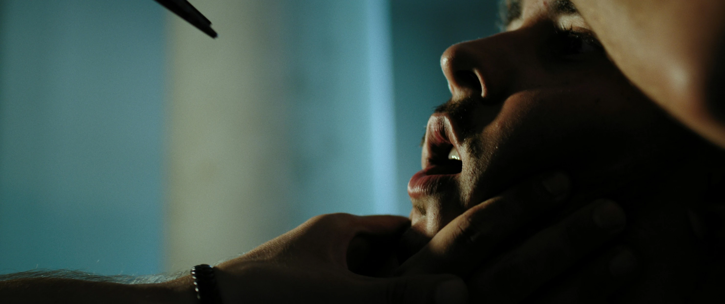 a close up of a person holding a toothbrush in her mouth