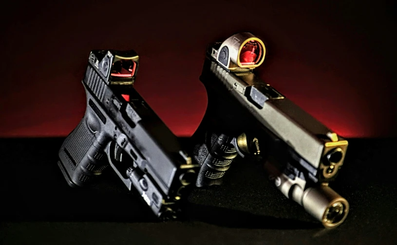 two toy guns with laser lights on one gun