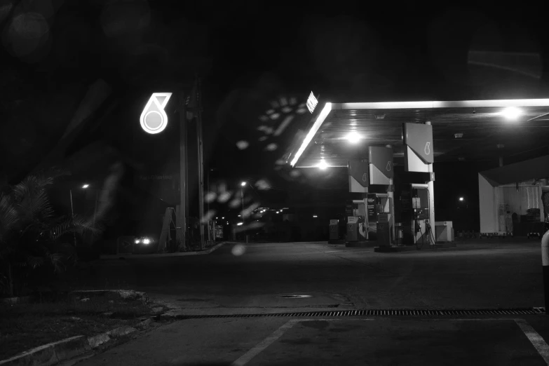 a car park with gas pumps at night