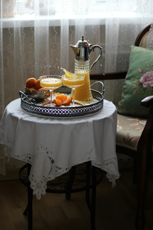 a tray that has an iron kettle and glasses on it