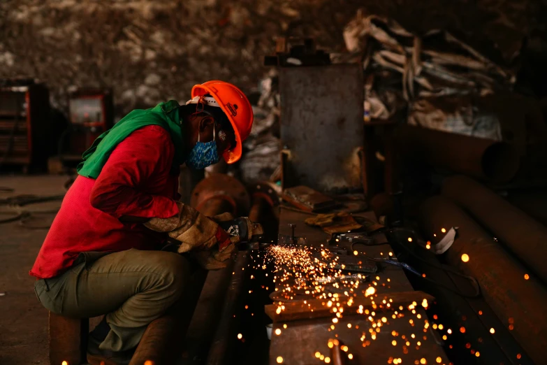 a person works on an iron item with lots of small sparks