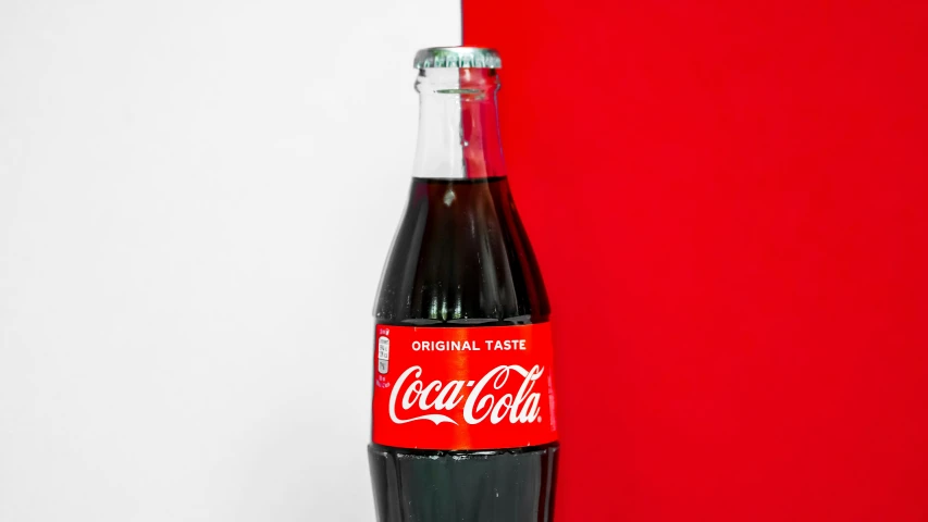 a red bottle with the words pepsi and a red background
