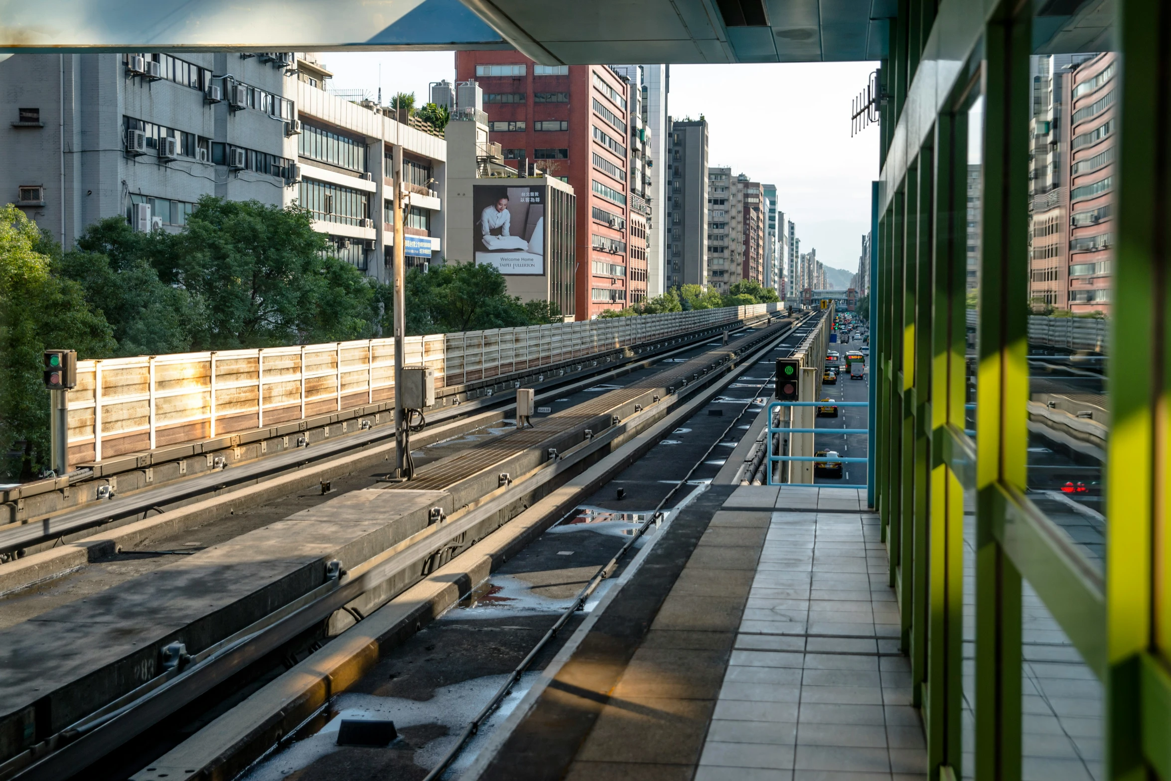 a train traveling along tracks next to a tall building