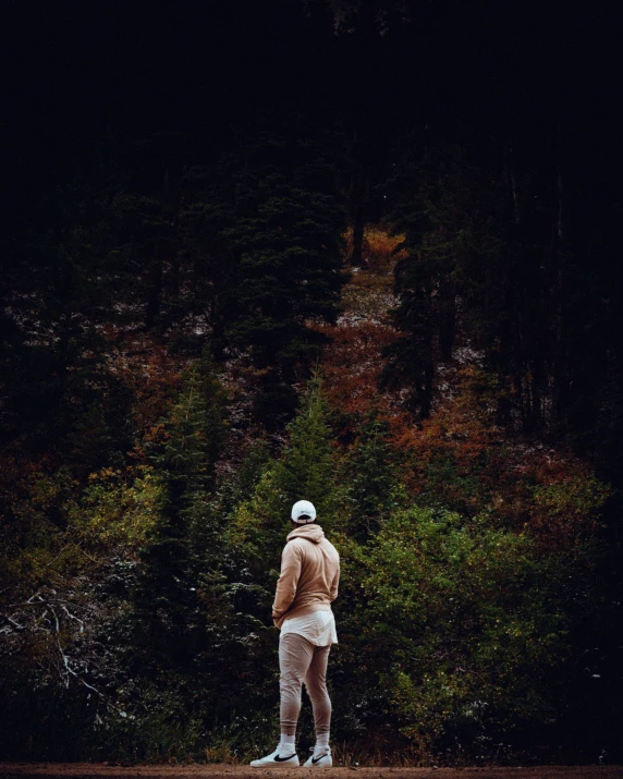 a person in all white standing on a road