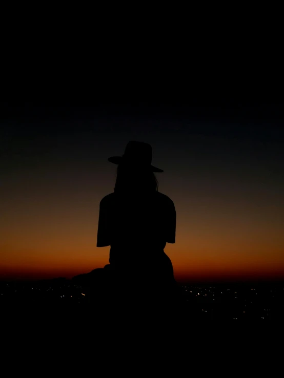 a silhouette of a person in the night