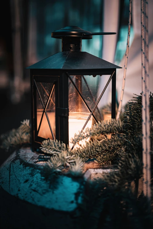 a candle that is lit in front of a lantern