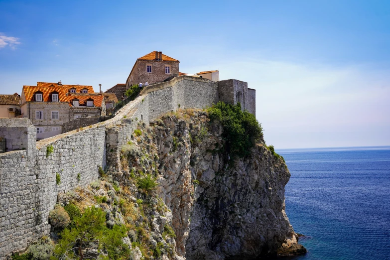 this picture shows an island with cliffs, rocks and houses