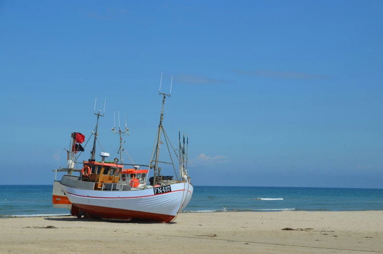 a boat that is sitting on a beach near the water