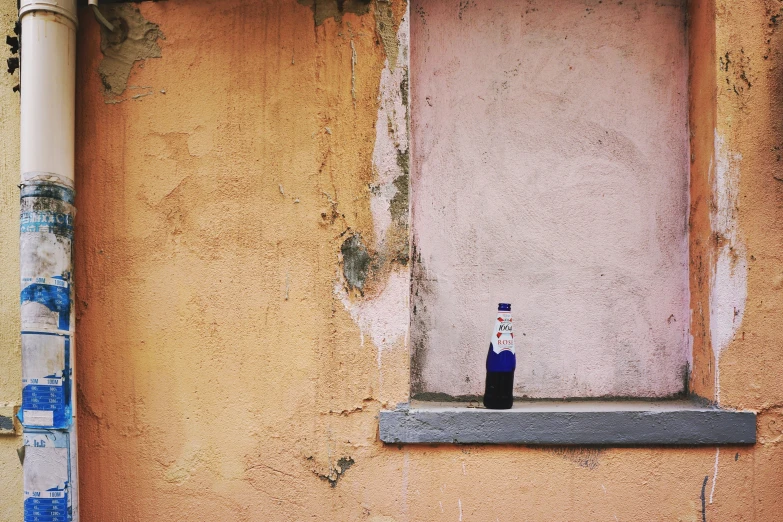 a bottle of vodka sitting on top of a window sill