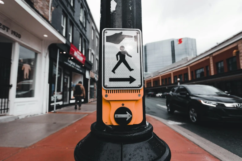 a crosswalk sign that is on top of a pole