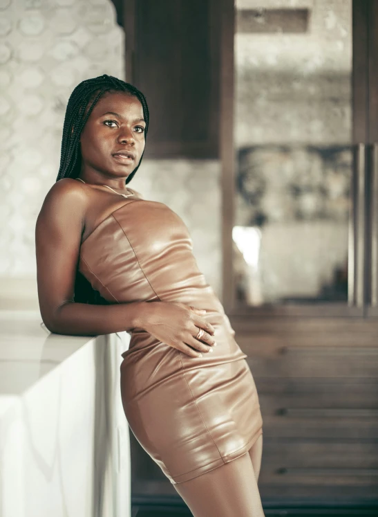 a beautiful young black woman in a dress posing