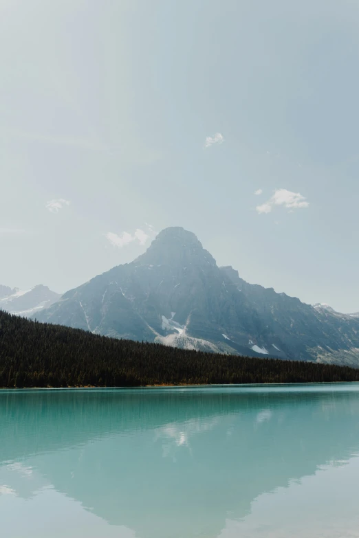 a large mountain range sitting next to a river