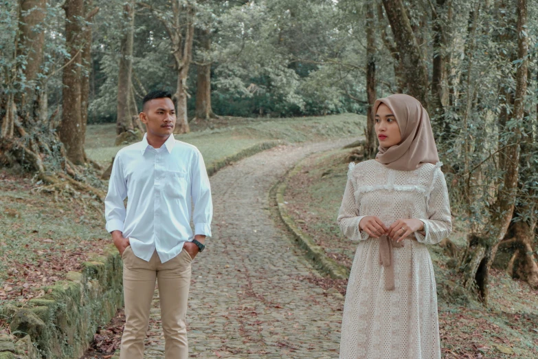 a man and a woman are standing on the road