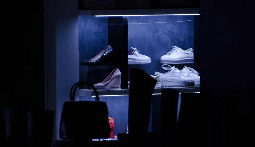 a store display showing two sets of white shoes