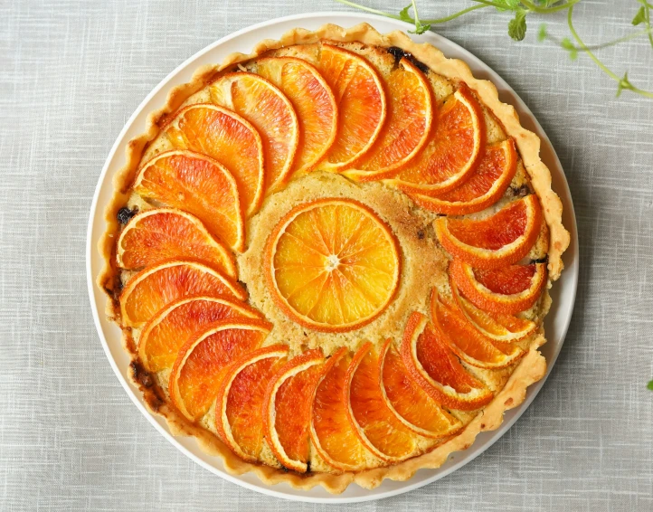 a delicious orange pie topped with slices of fresh tangerine