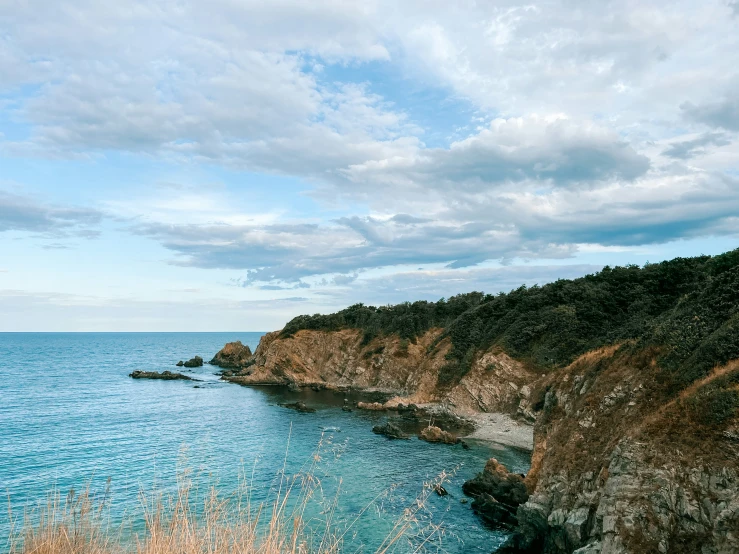 a very pretty blue ocean with white clouds