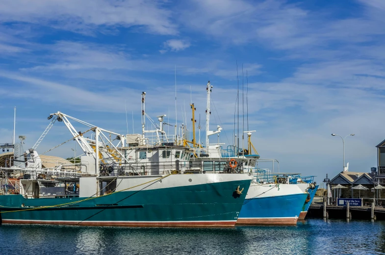 a boat with two masts docked at a dock