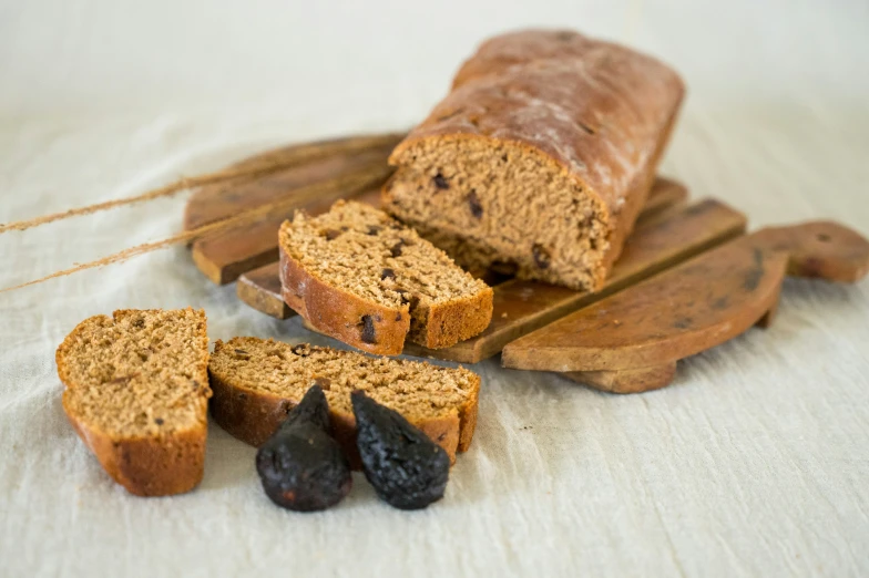 a bunch of bread sitting on top of a white cloth