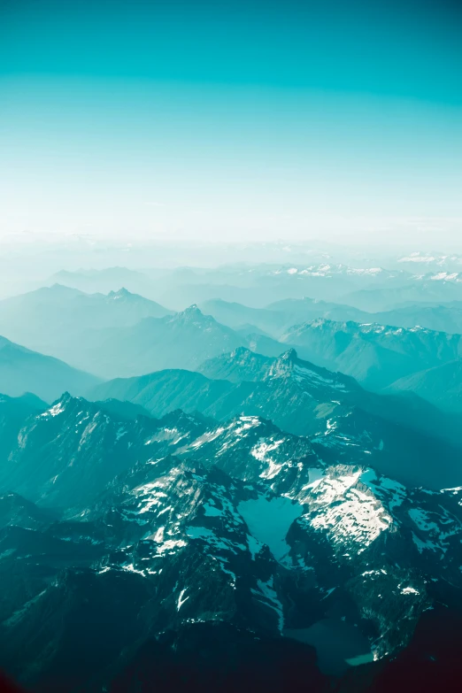 view from an airplane, of mountains and valleys