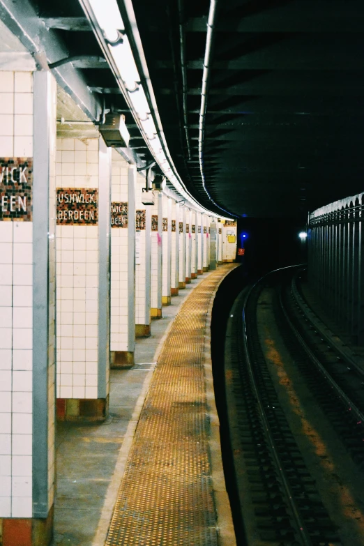 a train pulling up to an empty subway station