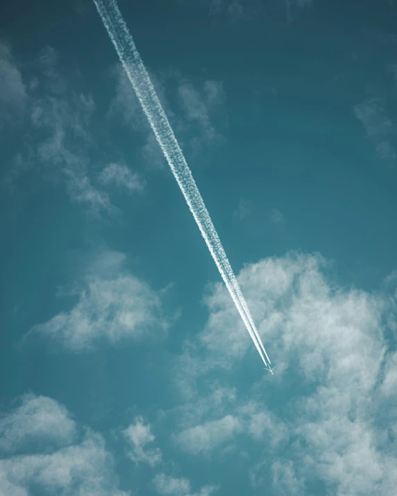 contrails are flying in the sky behind the jet