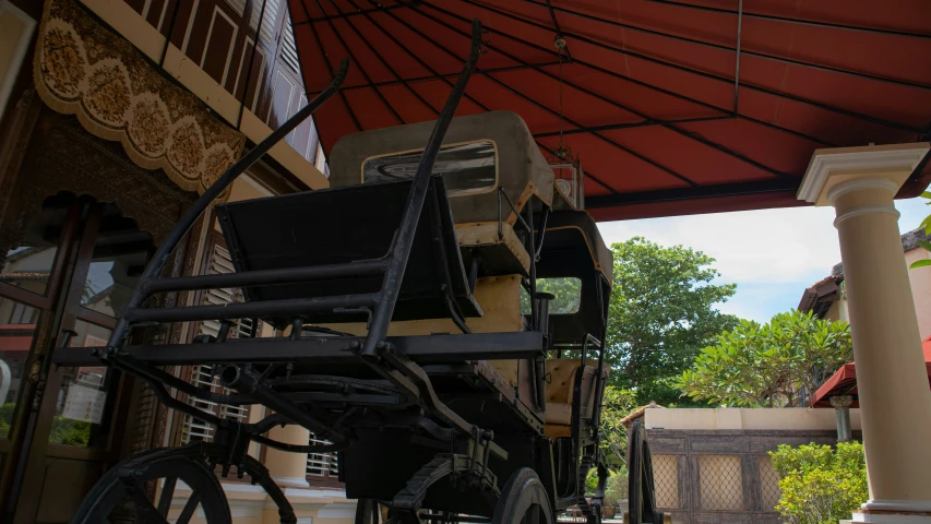 a horse drawn carriage under an orange covering