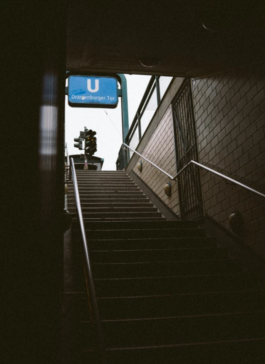 a stairway with hand rail going up into an underground