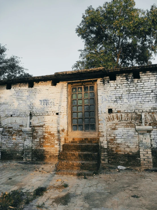 there is a old wall building with stone steps and a door