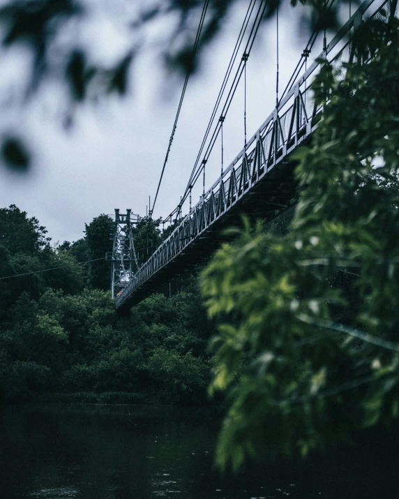 a long bridge hanging over a river below