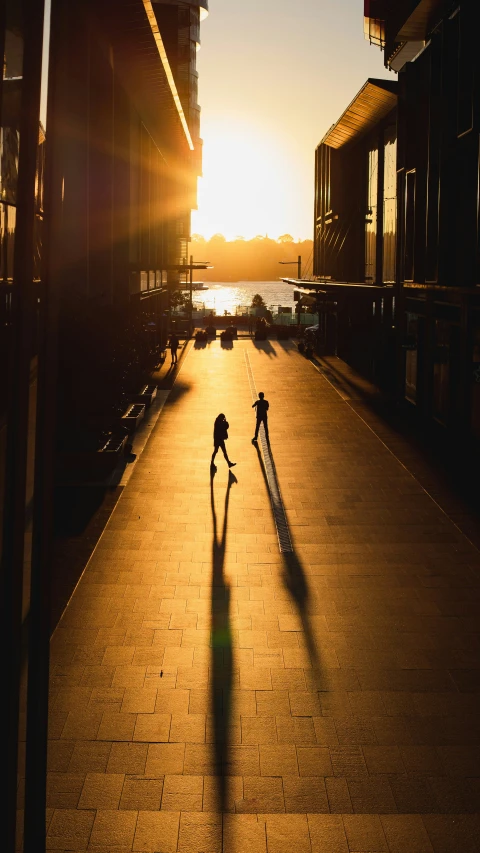 two skate boarders traveling on an empty walkway