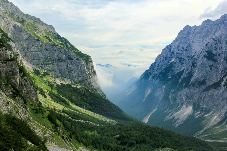 the view from the top of a mountain on a cloudy day