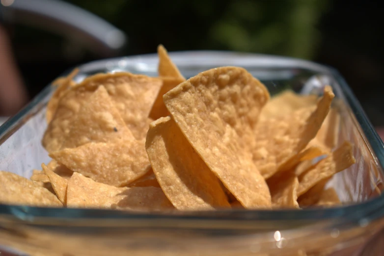 a bowl filled with corn chips in it