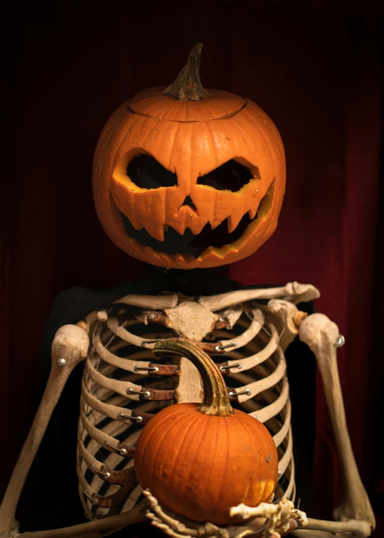a skeleton with a face full of pumpkins