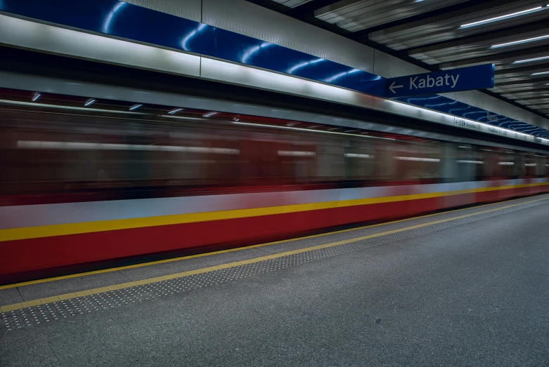 a speeding subway is in the city with lights and graffiti