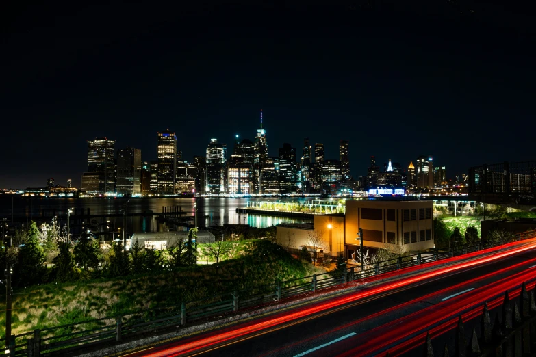 a night view of the city skyline with an illuminated bridge