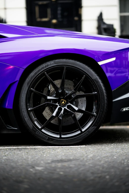 a purple sports car sitting in a parking lot