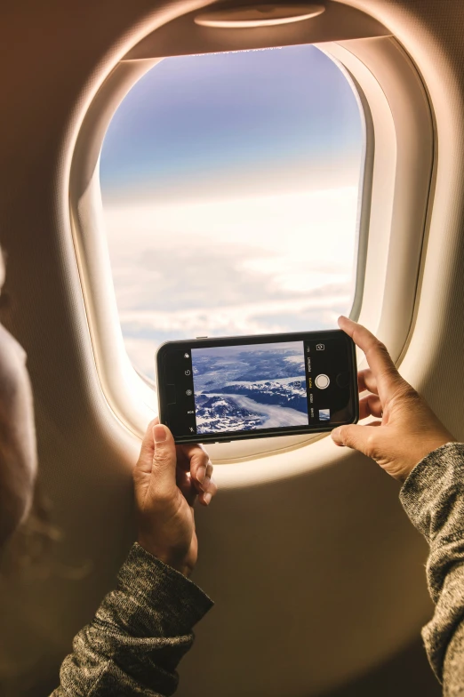 a person holding up their cell phone to take a po